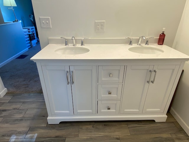 bathroom with vanity and wood-type flooring