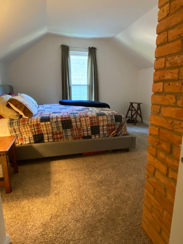 bedroom featuring lofted ceiling and carpet flooring