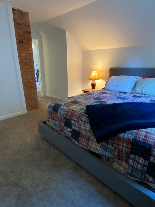 bedroom with carpet flooring and lofted ceiling