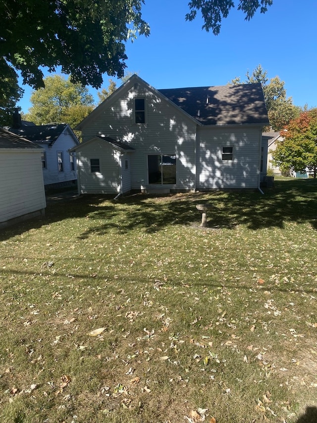 rear view of house with a yard