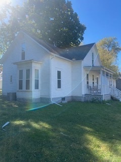 rear view of house with a yard