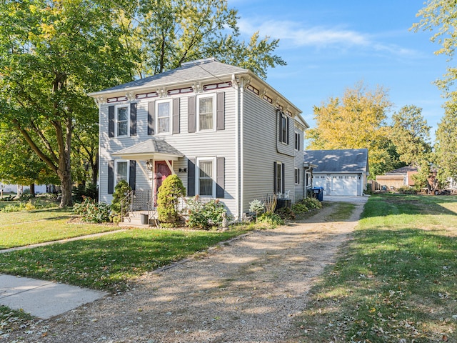 italianate home featuring central air condition unit, a front lawn, and a garage