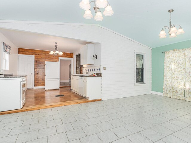 kitchen featuring white cabinetry, light wood-type flooring, and white appliances