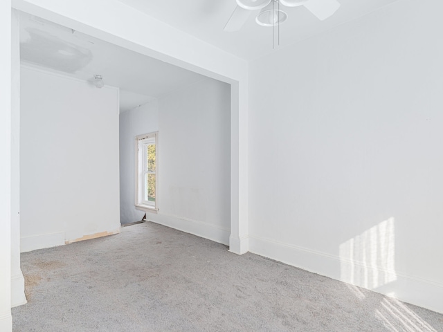 spare room featuring ceiling fan and light colored carpet