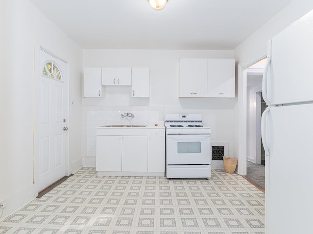 kitchen featuring white cabinetry, sink, and white appliances