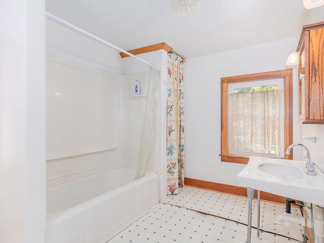 bathroom with shower / tub combo with curtain, baseboards, and tile patterned floors