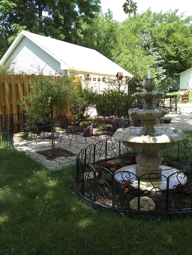 view of home's community with a patio and a yard