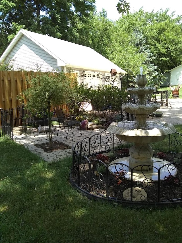 view of yard with fence and a patio