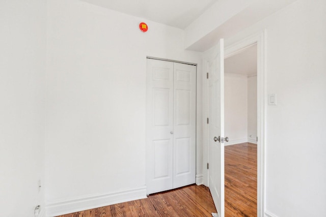 unfurnished bedroom with a closet and hardwood / wood-style flooring