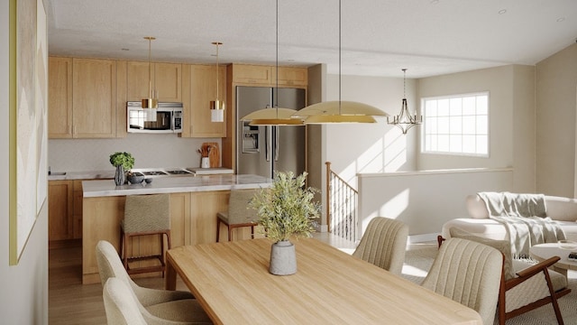 dining room with light hardwood / wood-style floors and an inviting chandelier