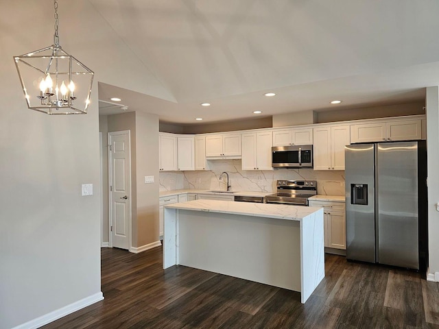 kitchen with white cabinets, appliances with stainless steel finishes, dark hardwood / wood-style floors, and sink