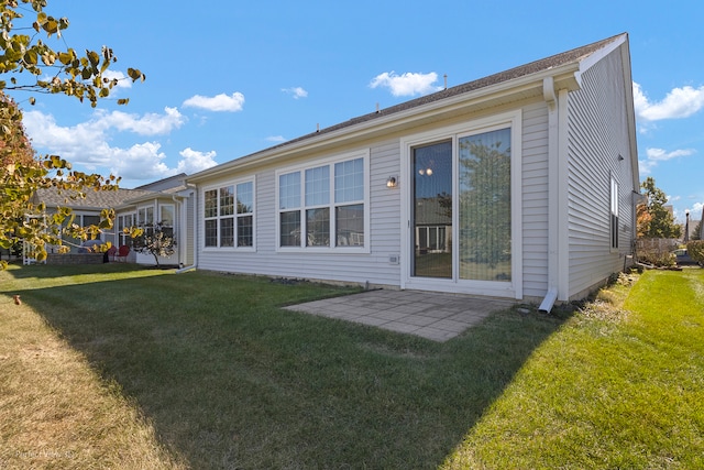 rear view of property with a lawn