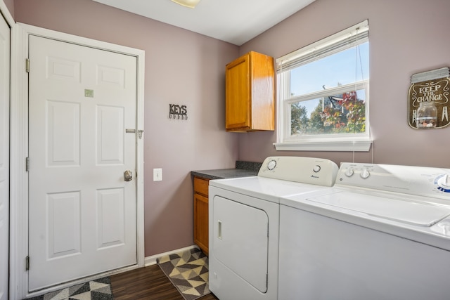 washroom with cabinets, independent washer and dryer, and dark hardwood / wood-style floors