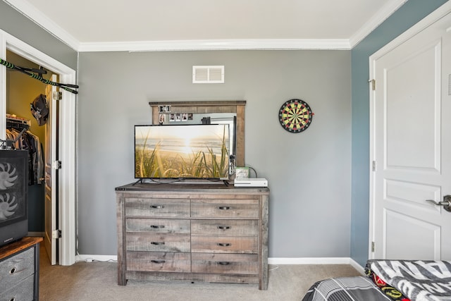 carpeted bedroom with crown molding and a closet