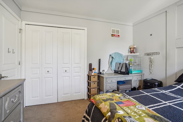 bedroom featuring ornamental molding, carpet floors, and a closet