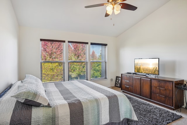 carpeted bedroom featuring ceiling fan and vaulted ceiling