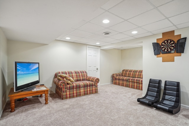 living area with carpet floors and a paneled ceiling