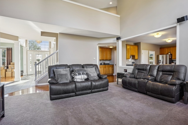 living room with a high ceiling and light wood-type flooring