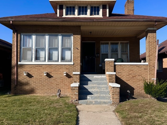 view of front of home with a front lawn and covered porch