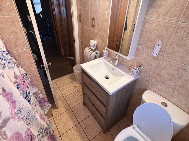 bathroom featuring vanity, tile walls, toilet, and tile patterned floors