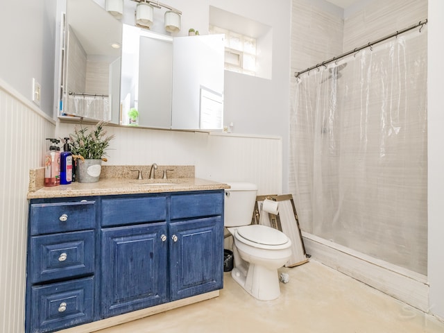 bathroom featuring toilet, vanity, and a shower with shower curtain