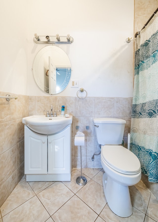 bathroom with toilet, tile patterned floors, and a shower with shower curtain