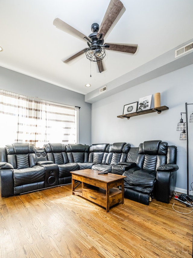 living room with light wood-type flooring and ceiling fan