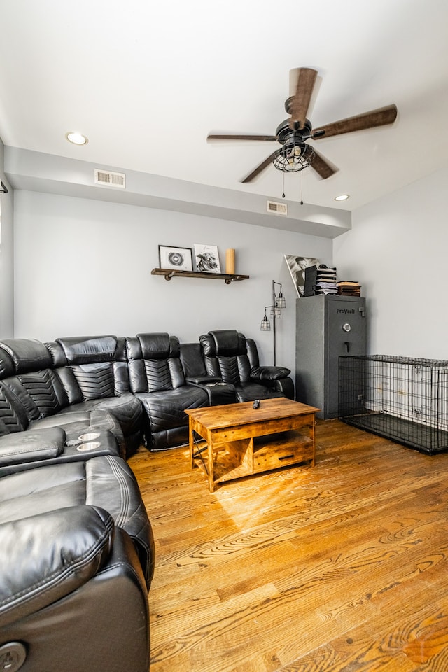 living room featuring hardwood / wood-style floors and ceiling fan