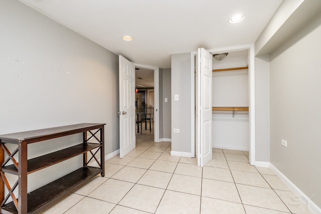 bedroom featuring a closet and light tile patterned floors