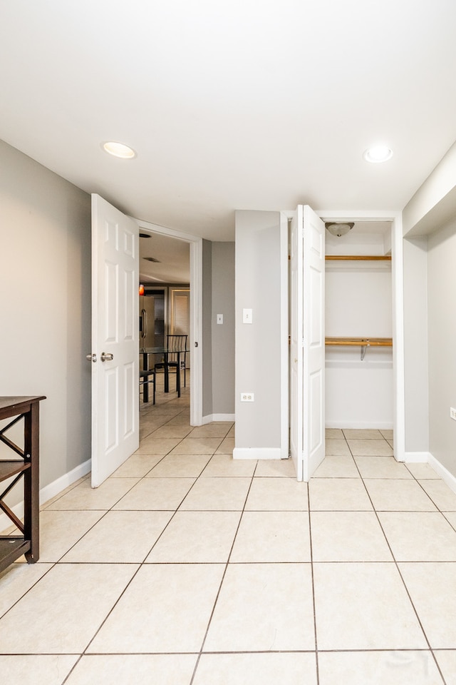 unfurnished bedroom with a closet and light tile patterned flooring