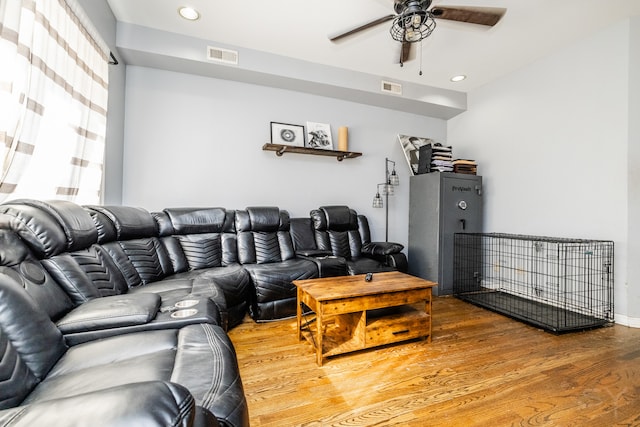 living room featuring hardwood / wood-style floors and ceiling fan