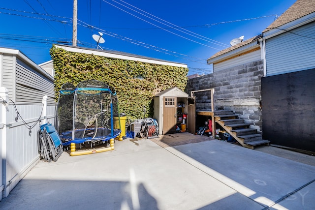 view of patio featuring a storage shed and a trampoline