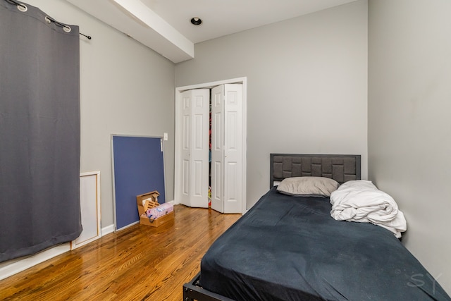 bedroom featuring wood-type flooring and a closet