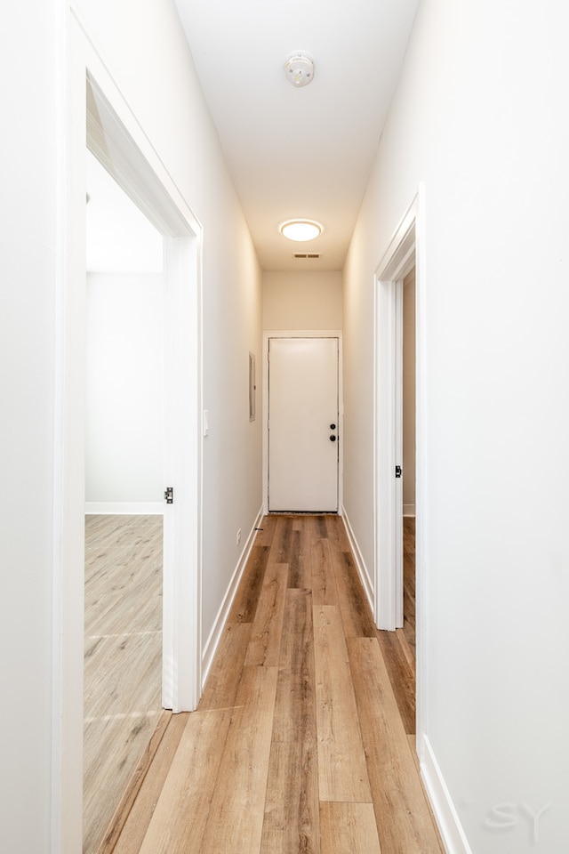 hall with light wood-type flooring