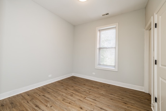 empty room with hardwood / wood-style floors