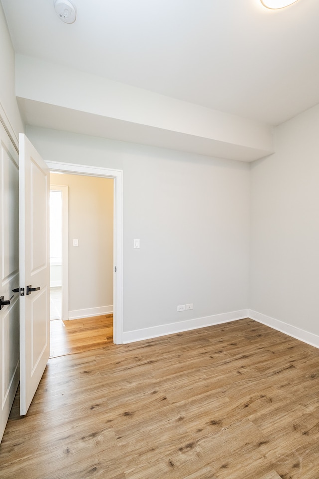 spare room featuring light hardwood / wood-style floors