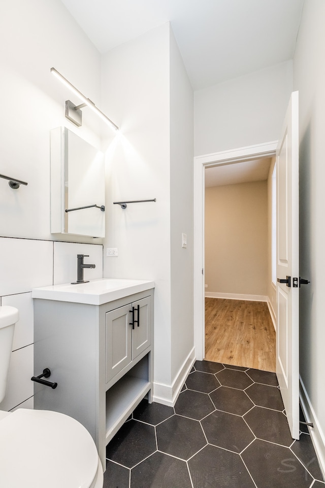 bathroom featuring vanity, toilet, and wood-type flooring