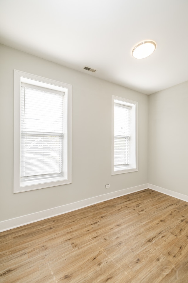 spare room featuring light wood-type flooring