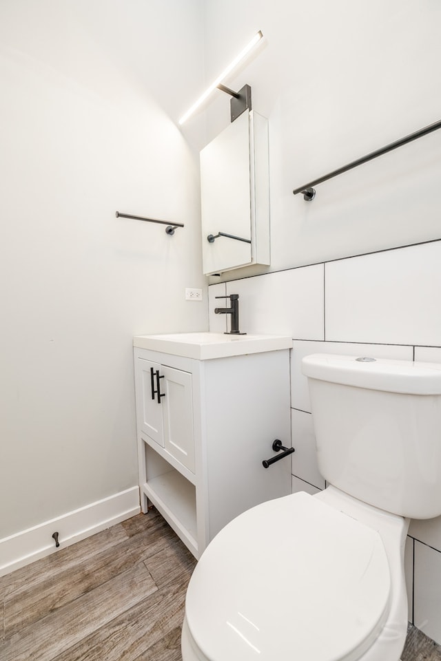 bathroom featuring vanity, toilet, and hardwood / wood-style floors