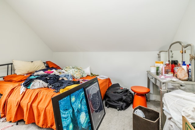 carpeted bedroom with lofted ceiling