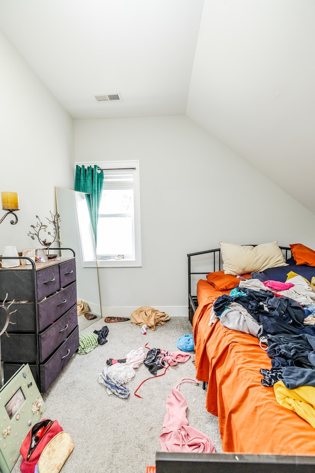 bedroom featuring lofted ceiling and carpet floors