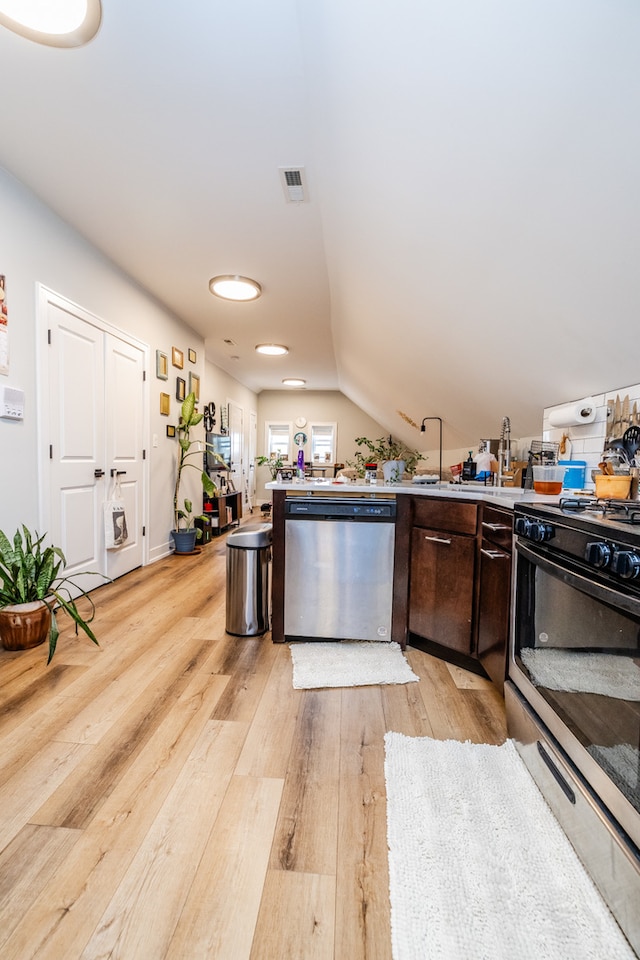 kitchen featuring light hardwood / wood-style floors, lofted ceiling, stainless steel appliances, and dark brown cabinets