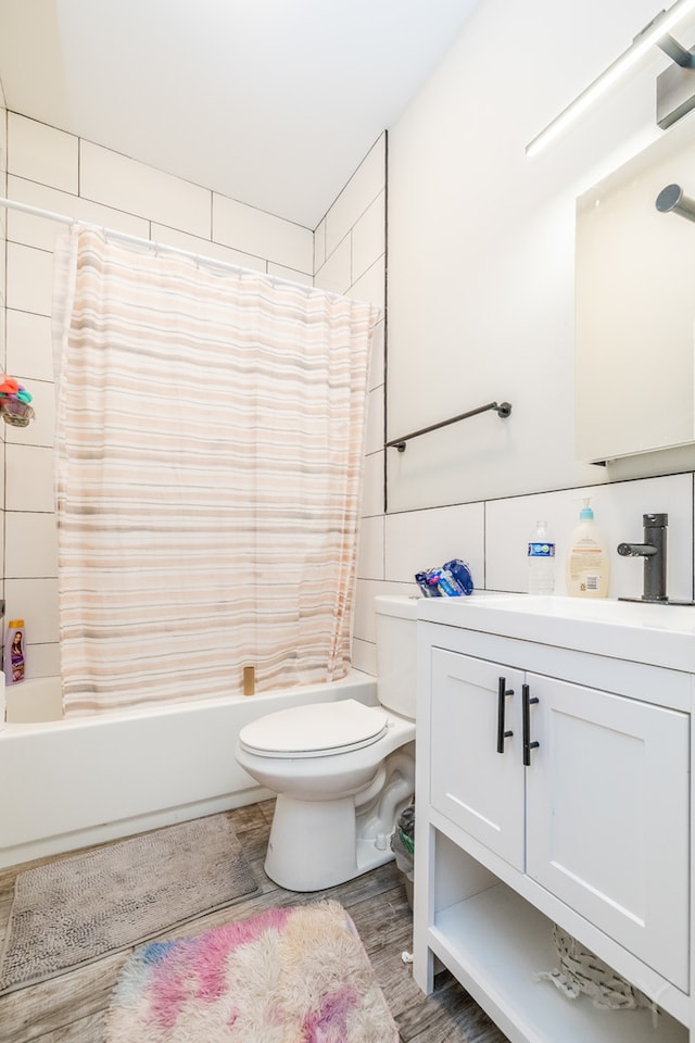 full bathroom with vanity, wood-type flooring, toilet, and shower / bathtub combination with curtain