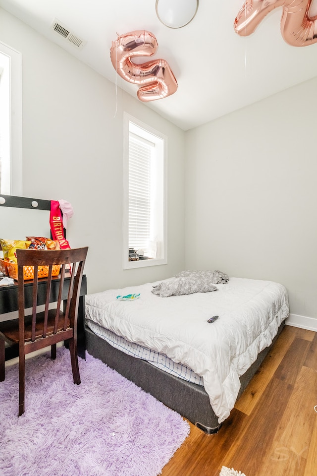 bedroom with hardwood / wood-style flooring