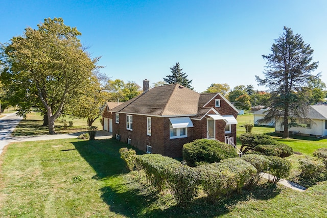 view of property exterior featuring a lawn