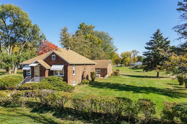 view of side of home featuring a lawn