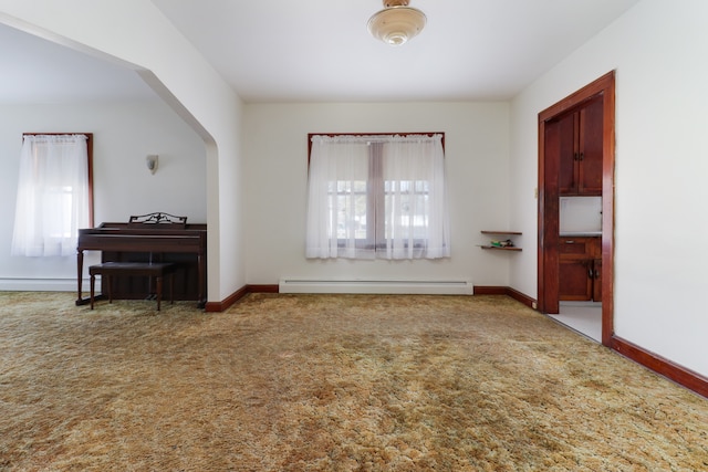 interior space featuring a baseboard radiator and a healthy amount of sunlight