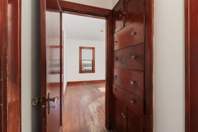 hallway with hardwood / wood-style floors