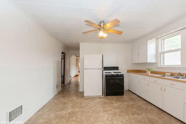 kitchen featuring black gas range, ceiling fan, white cabinetry, sink, and white refrigerator