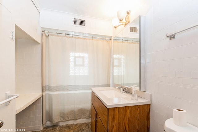 bathroom featuring tile walls, vanity, a shower with shower curtain, and toilet